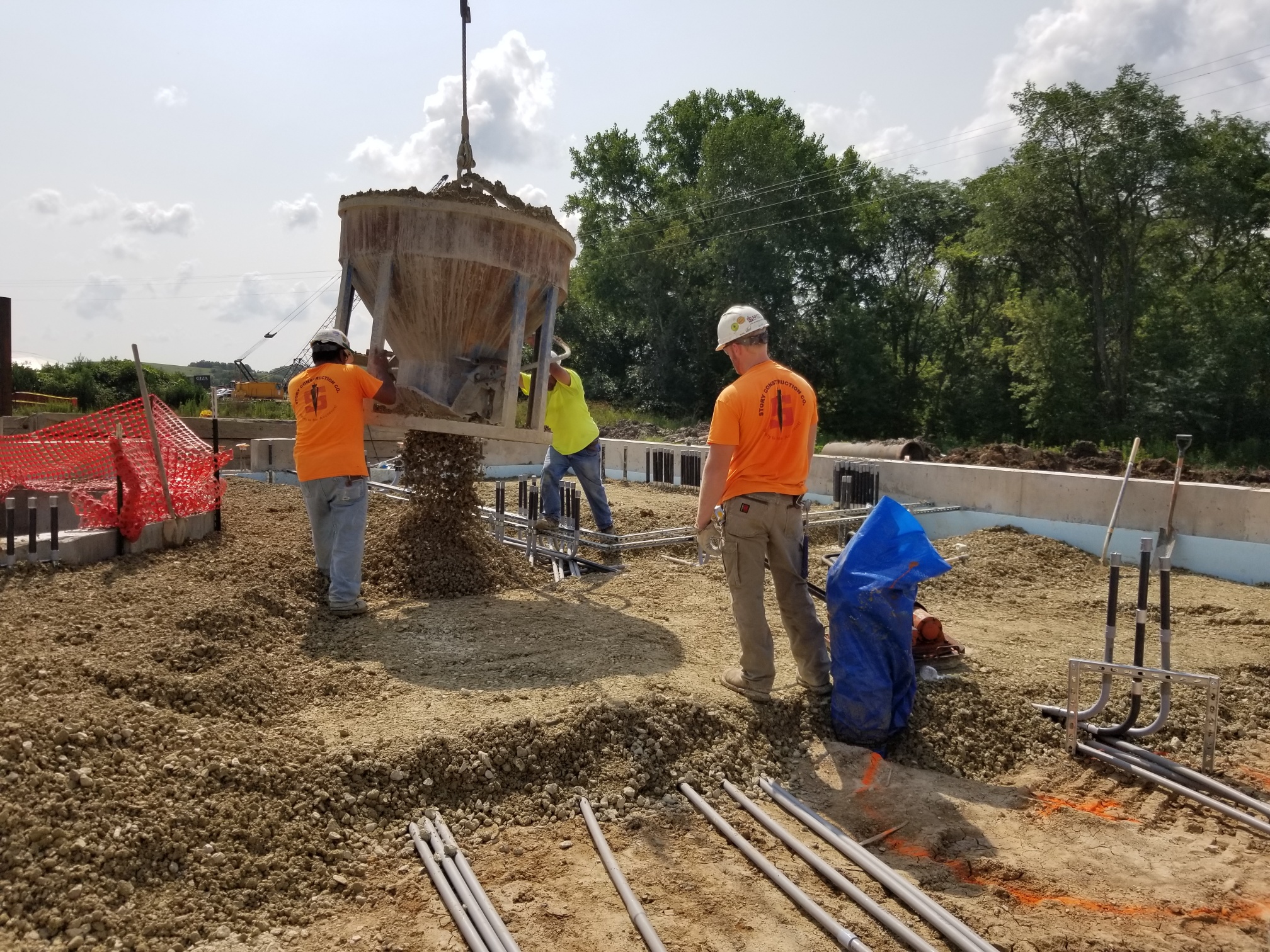 Story Construction crews overseeing the placement of a gravel rock base.